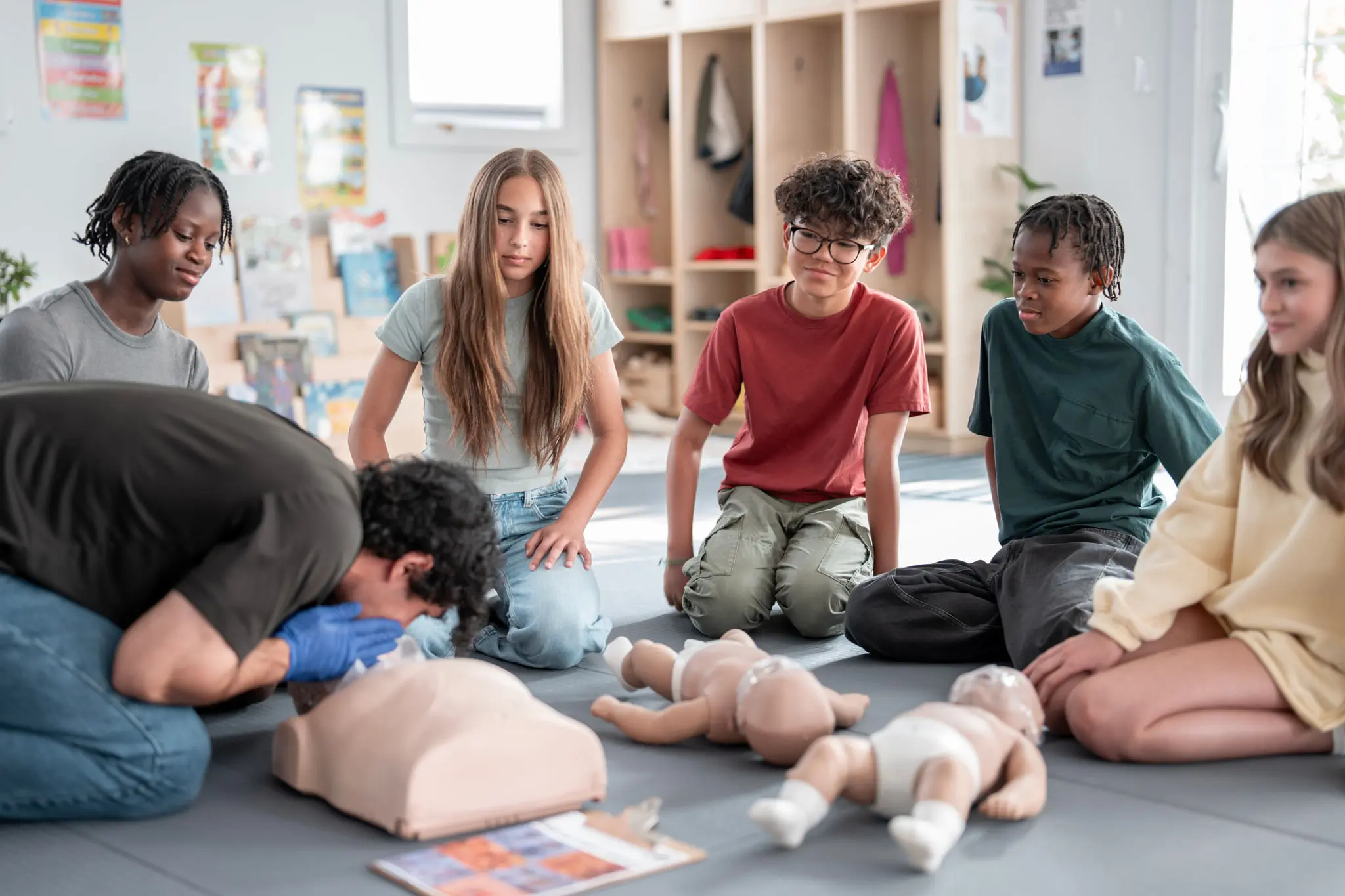 CPR training session with attentive students watching.