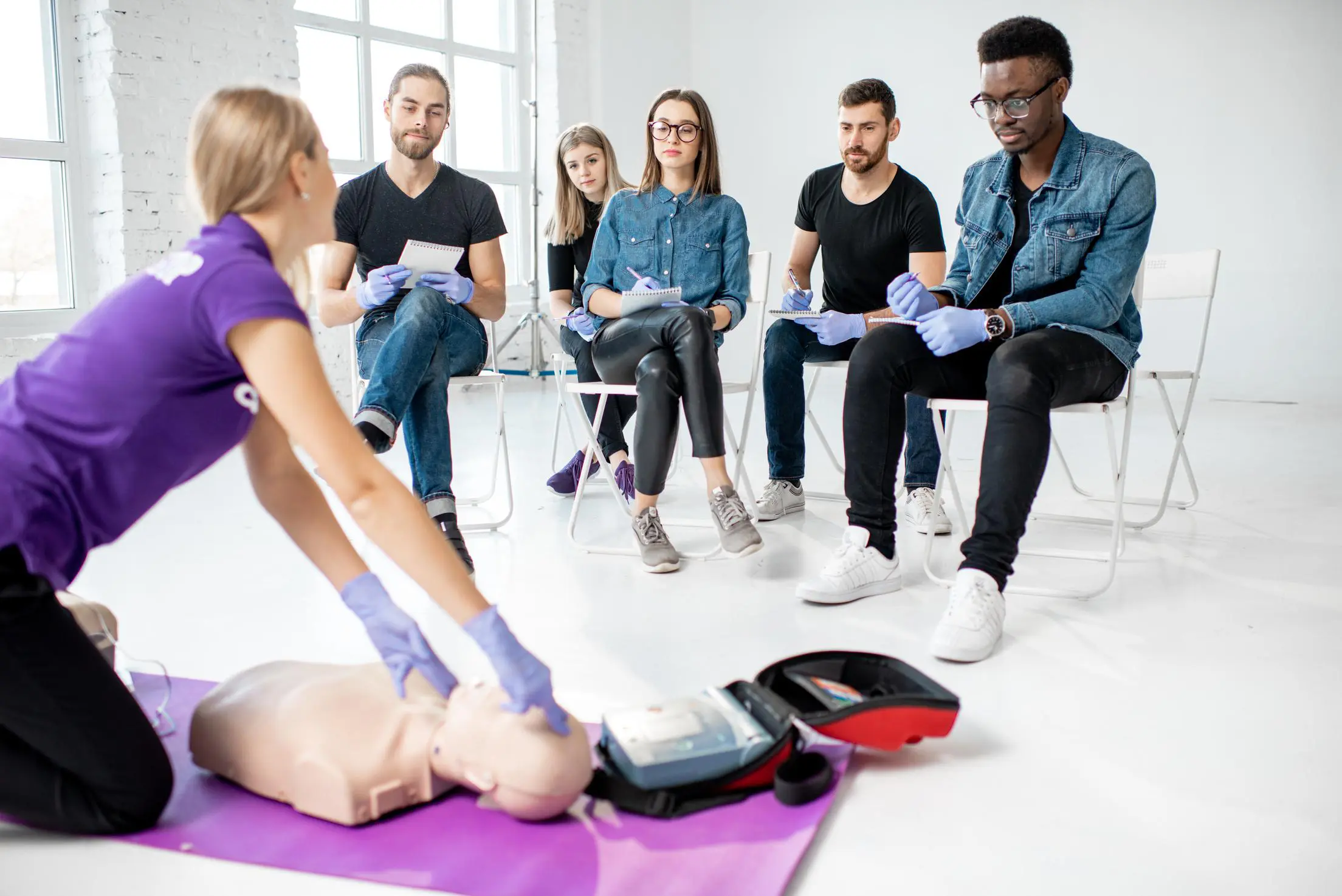 CPR training session with attentive participants.